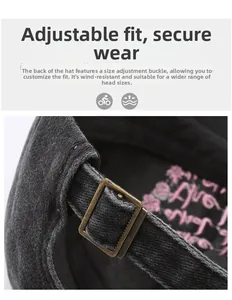 Macro shot of adjustable bronze metal buckle and pink embroidery on a washed baseball cap