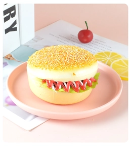 Macro shot of realistic artificial burger model with detailed sauces and sesame bun texture