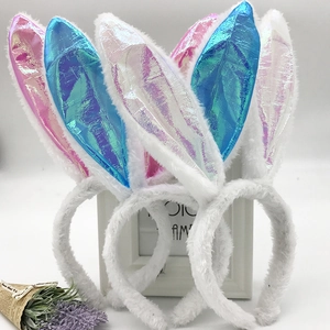 Three sequined plush bunny ear headbands in pink, blue, and white iridescent colors