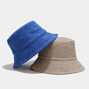 Terry cloth bucket hats in navy blue and beige with reinforced stitching for sun protection