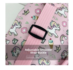Detail of adjustable pink nylon shoulder strap with cartoon unicorn patterns and buckle