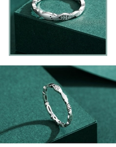 Macro view of minimalist S925 sterling silver ring with engraved fish patterns