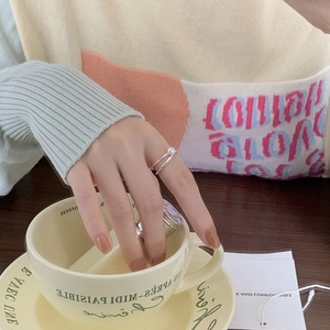 Detail of 925 sterling silver pearl ring worn on hand with elegant lifestyle aesthetic