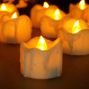 Close-up of LED tea light candles with warm yellow glow and realistic melted wax texture