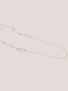 Macro detail of warm gold metal eyewear chain with stylish eyeglass-shaped pendants
