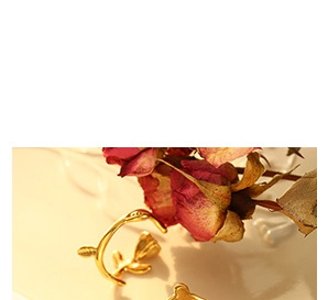 Macro shot of gold rose ring with detailed petals and vintage texture design