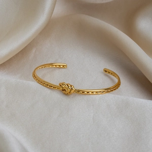 Bracelet jonc ouvert nœud plaqué or 18K avec texture corde tressée sur fond en soie