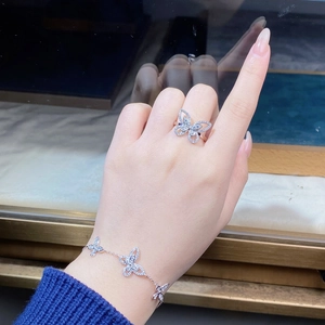Close-up of S925 sterling silver butterfly ring and tennis bracelet with sparkling zircons