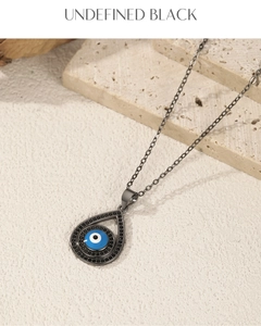 Macro shot of S925 sterling silver evil eye necklace with black zircon on stone base