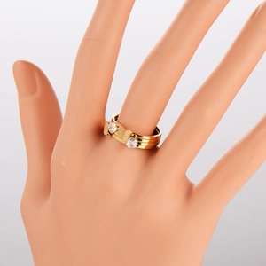 Detail of multi-layer gold ring featuring a sparkling zircon butterfly design on model hand