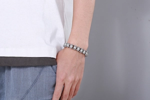 Close-up of a silver stainless steel biker chain bracelet worn on a male wrist