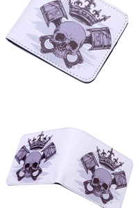 Close-up of white bifold wallet featuring skull and crown prints with tidy stitching