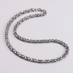 Detailed close-up of a silver stainless steel square Byzantine king chain for men
