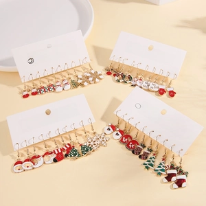 Flat lay detail of festive Christmas stud earring sets featuring enamel holiday charms