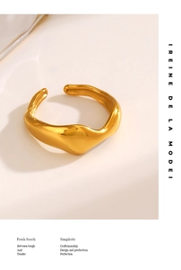 Close-up of golden irregular wavy ring with polished finish on beige background