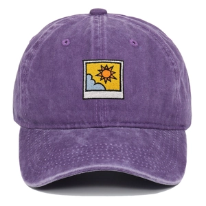 Close-up of purple washed cotton baseball cap with sun and clouds embroidery patch