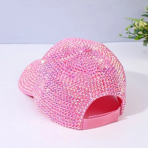 Detailed close-up showing pink rhinestones and adjustable strap on a sparkling baseball cap