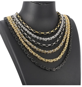Multiple colors of 5mm Byzantine chain stainless steel necklaces on black displays