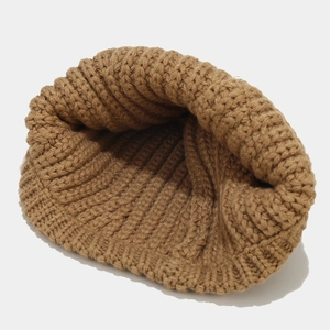 Brown knit bucket hat for winter featuring a thick ribbed texture and minimalist design