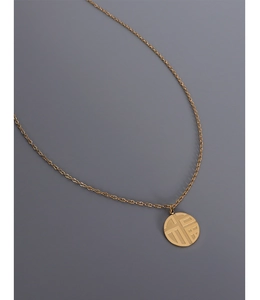 Detailed view of an 18K gold-plated titanium necklace with a round Fu character pendant