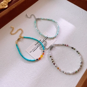 Detailed close-up of handmade natural stone beaded bracelets with adjustable lobster clasps