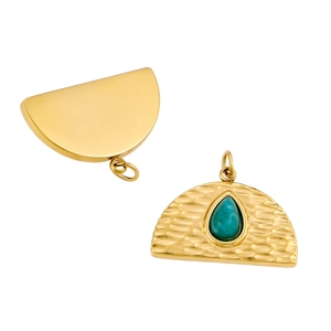 Water ripple stainless steel pendant with green gemstone in a vintage gold finish