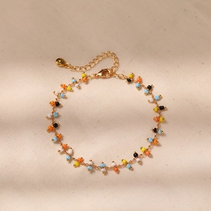 Close-up of colorful seed beads on a gold-plated chain with lobster clasp and extender