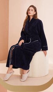 Close-up of plush navy bathrobe with white piping and soft fleece texture detail