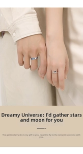 Detail of couple rings featuring blue starry sky glass and tiny astronaut charms