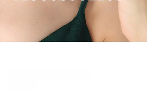 Close-up detail of dark green textured camisole dress showing delicate shoulder straps