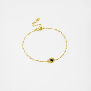 Detailed shot of golden s925 silver bracelet featuring blue and clear gemstone pendant