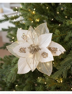 Detail of 25cm white mesh Christmas flower with gold glitter edges on a holiday tree