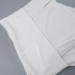 Macro shot of the white ribbed knit fabric texture on this off-shoulder slim-fit top