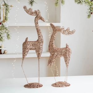 Glittery rose gold metal reindeer figurines for Christmas window display and home decor