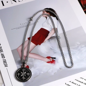 Detailed view of vintage star pendant with black enamel on a silver twisted chain