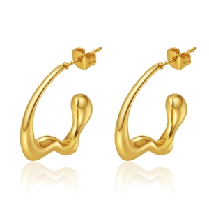 Macro detail of high-shine gold 18K plated irregular C-shape stainless steel earrings