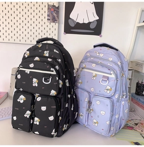 Detail of cute bear print backpacks in black and lavender with large capacity pockets