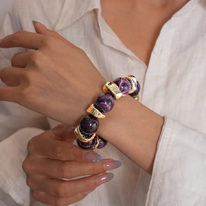 Dettaglio di bracciale vintage in acrilico con perle geometriche e accenti dorati