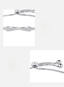 Detail of adjustable silver bow bracelet with sparkling pavé cubic zirconia inlay