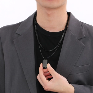 Detail of double-layer men's necklace with black square pendant on leather and metal cord
