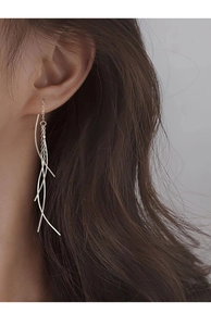 Elegant s925 sterling silver tassel drop earrings worn by a model in a close-up detail shot