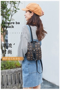 Outdoor lifestyle shot of a printed mini backpack featuring security buckle and black straps