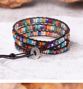 Detail of bohemian wrap bracelet with colorful crystal beads and leather weaving