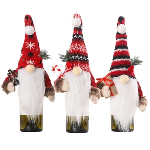Three Christmas gnome wine bottle covers with red and black knit hats and white beards