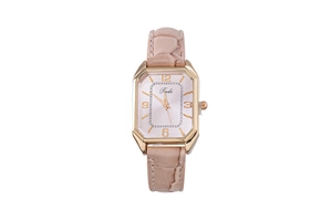 Detail of octagonal gold watch case with pink dial and crocodile pattern leather strap