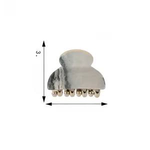 Detail view of mini marble acrylic hair claw clip with gold metal teeth and 4cm dimensions