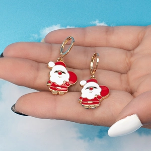Boucles d'oreilles Père Noël mignonnes en émail rouge et or sur fond de ciel bleu