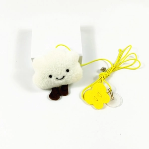 Detail of plush cloud cat toy with yellow hanging rope and small metal jingle bell