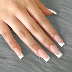 Long square white French tips press-on nails with natural pink base on a soft fur background