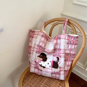 Detail of pink checkered canvas tote bag with cute cartoon dachshund embroidery